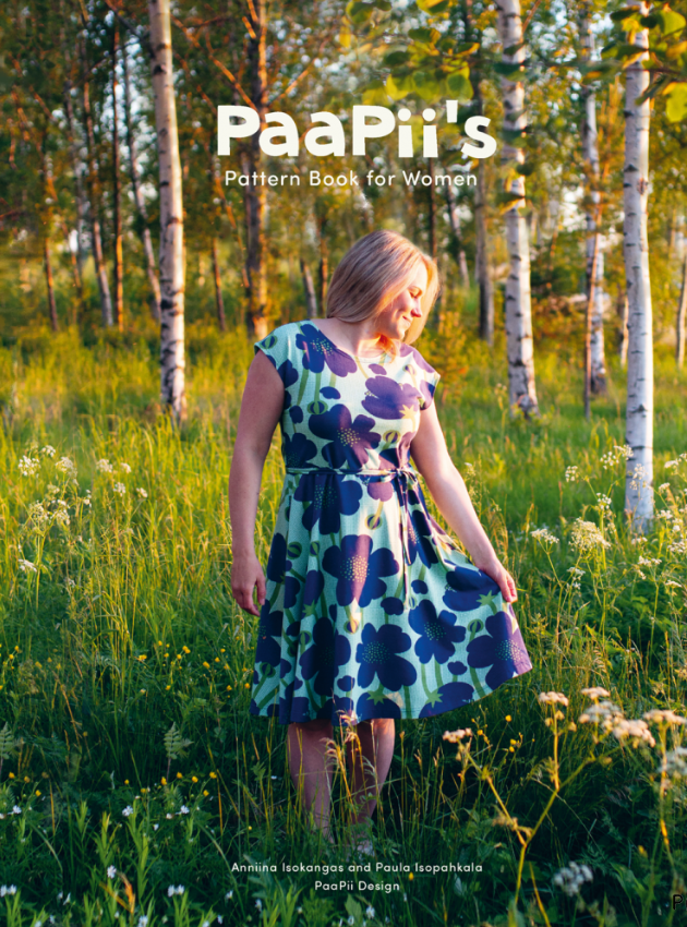 Woman in a floral dress standing in a forest with 'PaaPii's' branding.